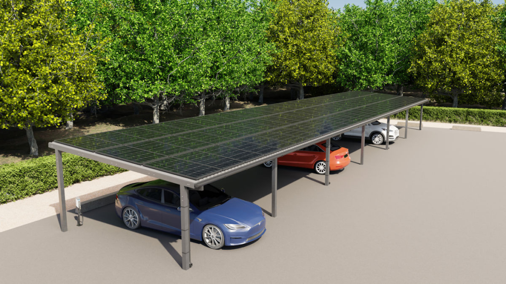 Modern commercial solar carports with a full canopy of solar panels providing shade for several electric and gas-powered cars in a parking lot, surrounded by lush green trees.